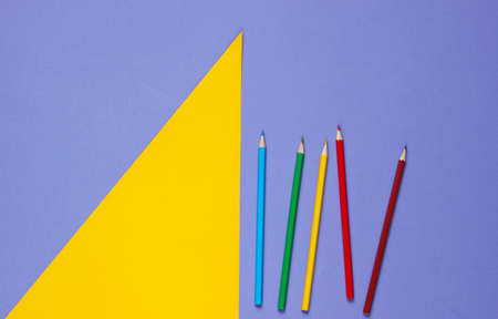 Color pencils on a purple yellow background. Studio shot