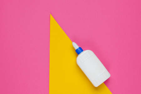 Bottle of glue on a color studio paper background. Top viewの写真素材