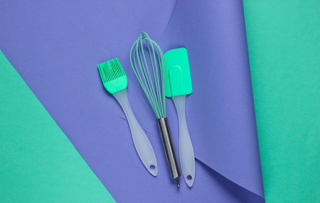 Kitchen tools on wrapped paper background. Minimalistic cooking still life. Pastel color trend