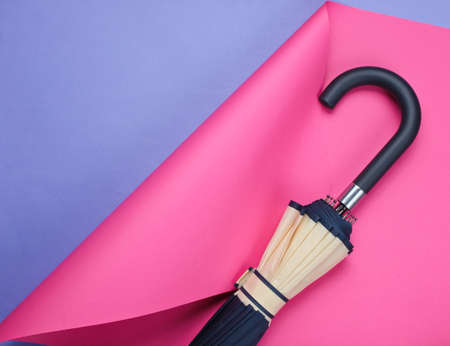 Umbrella hook on colored folded paper background. Minimalistic fashion still life. Flat lay. Top viewの写真素材