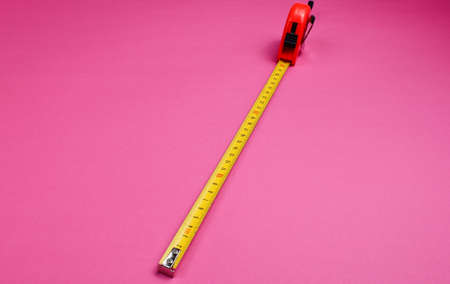 Industrial ruler on pink background. Close upの写真素材