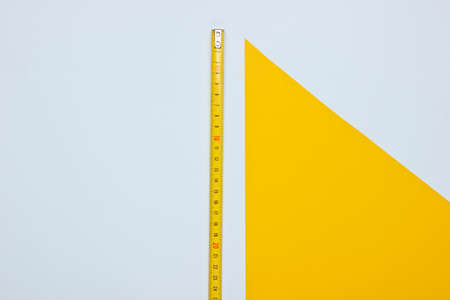 Industrial ruler on yellow white background. Top viewの写真素材
