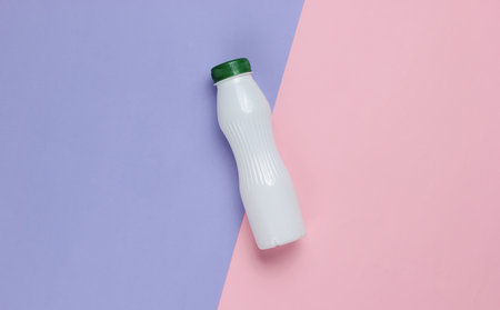 Yogurt bottle on pastel paper background. Top viewの写真素材