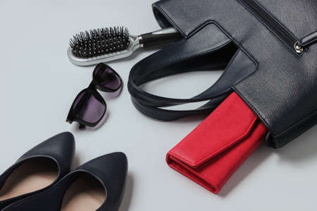 What's in the bag? Women's accessories, shoes on white background. Top view, minimalism. Beauty and fashionの写真素材