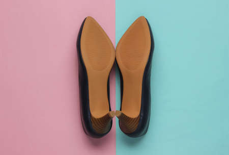 the sole of leather women's shoes with heels on blue-pink pastel background. Minimalistic fashion. Top viewの写真素材