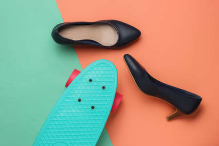 Summer fun. Women's high heel shoes with cruiser board on pink blue studio background. Fashion shot, top viewの写真素材