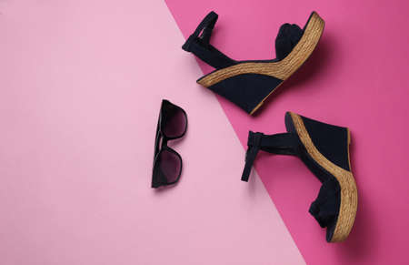 Women's sandals with platform, sunglasses on pastel background. Women's summer shoes and accessories. Top view.の写真素材