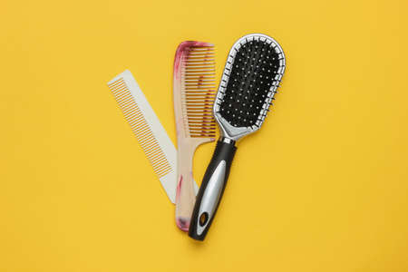 Combs on yellow background. Beauty minimalistic concept. Hair care.の写真素材