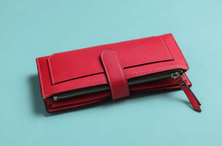 Red leather wallet on blue background.