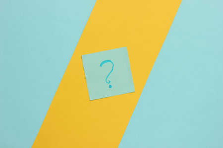 Memo pieces of paper with question mark on colored background. Top viewの写真素材