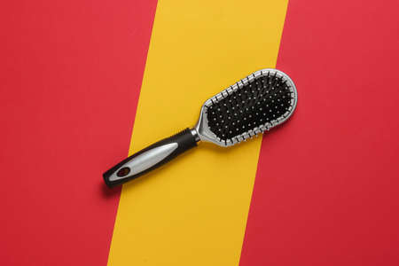 Comb on a yellow-red background. Top viewの写真素材
