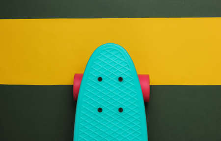 Cruiser board on colored paper background. Summer fun. Studio shot. Top viewの写真素材