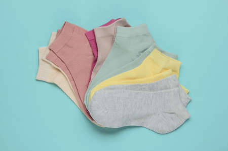 Set of pastel color socks on blue background. Top viewの写真素材
