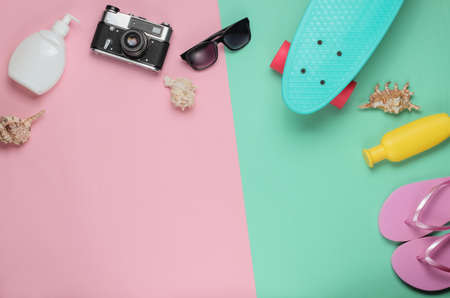 Overhead view of woman's swimwear. Summer fun background. Summer beach accessories on pink blue pastel background. Top view. Flat lay style. Copy spaceの写真素材