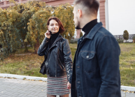Romantic date. A young couple of lovers walking around the city and holding handsの写真素材