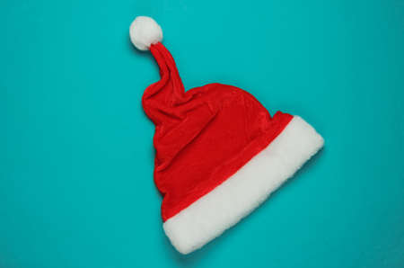 Santa hat on blue background. New Year, Christmas minimalistic concept. Top view, studio shot.の写真素材