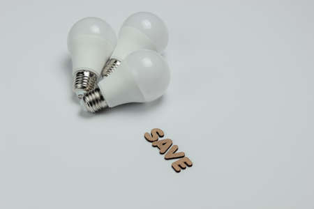 Eco three LED light bulbs on blue background. Save energy concept. Top view