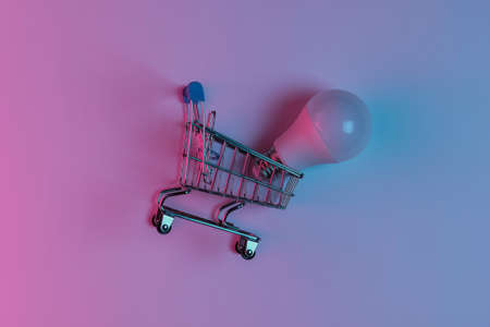Shopping trolley with LED light bulbs. Neon pink blue night lightの写真素材