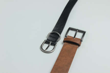 Two leather belts on white background close-up
