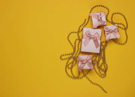 Gift boxes, garlands on yellow background. Christmas concept. Copy space. Top viewの写真素材