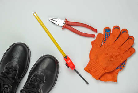 Flat lay composition with different industrial working tools and instruments, safety equipmen on white background. Top viewの写真素材