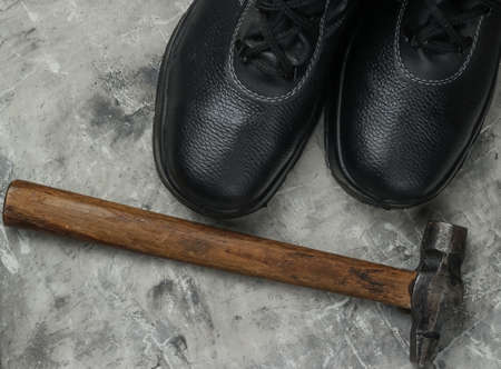 Work leather shoes and hammer.の写真素材