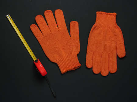 Work gloves, tape measure. Construction workers tools and instrumentsの写真素材