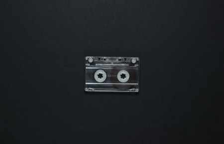 Audio cassette on a black background. Top view