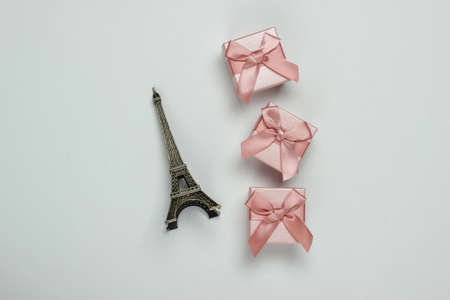 gift boxes with bows and a statuette of the Eiffel Tower on a white background. Shopping in Paris, souvenirsの写真素材
