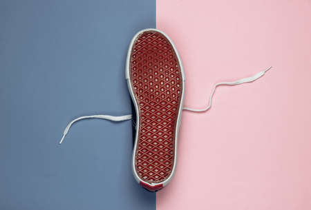 Sole up sneaker on a blue pink background. Top viewの写真素材