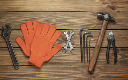 Set of professional work tools on wooden background. Top view.