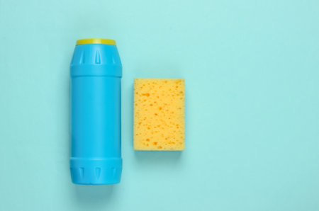 Ready for cleaning! Housework concept. Detergent bottle, sponge on blue pastel background. Top viewの写真素材