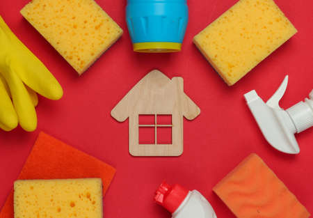 Housekeeping concept. Set of products for cleaning and house figure on red background. Top view.の写真素材