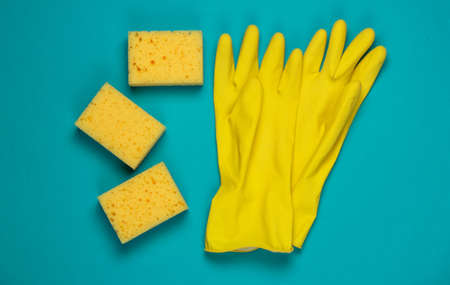 Sponges, gloves on blue background. Top view. Minimalismの写真素材