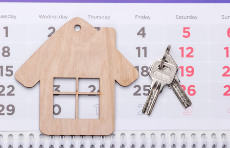 Payment of rent for housing. Mini house figurine on calendar.の写真素材