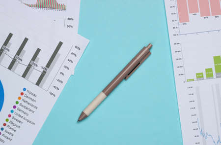Business analysis. Financial analytics. Pen with graphs and charts on blue background. Top viewの写真素材