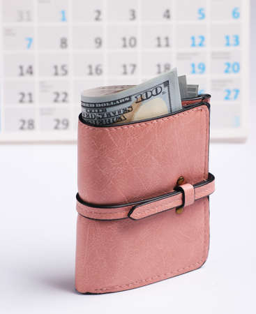 Wallet with dollar bills, desktop calendar on white background. Holiday shoppingの写真素材