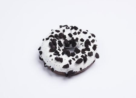 Glazed donut sprinkled with chocolate pieces on a white background. Sweets cake, unhealthy foodの写真素材