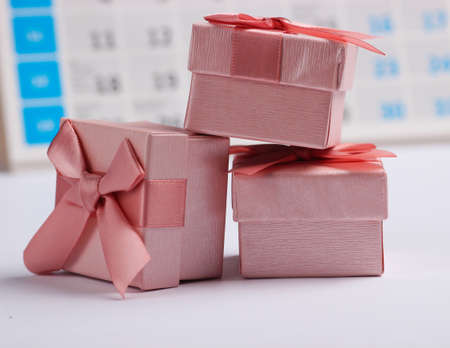 Gift boxes with desktop calendar on white background. Holiday shopping, black friday, monthly...