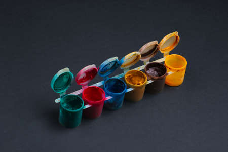 Gouache bottles of paint on black background.の写真素材
