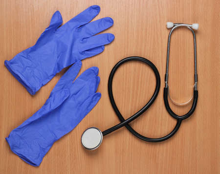Workspace of a doctor. Stethoscope and gloves on the office desk