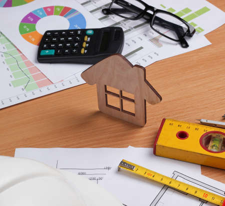 Architectural project plan, statistics and charts. Engineering tools and office supplies on table,...