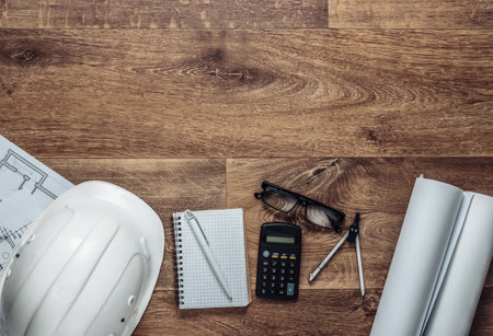 Creative layout of architects with roll drawings, engineering tools and stationery on floor, workspace. Top view. Flat lay. Copy spaceの写真素材