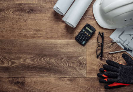 Creative layout of architects with roll drawings, architectural project plan, engineering tools and stationery on floor, workspace. Top view. Flat lay. Copy spaceの写真素材