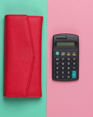 Calculator with a leather wallet on a blue-pink pastel background. Family bujet, economical calculation, additional accounts of expenses. Top viewの写真素材
