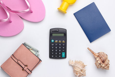 Calculation of the cost of rest. Summer background. Traveler, beach accessories, calculator on white background. Top view.の写真素材