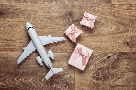 Air delivery. Plane figurine and gift boxes on floor. Flat lay. Top viewの写真素材