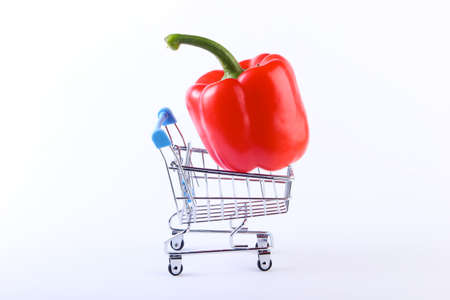 Mini Shopping trolley with red bell pepper on a white background. Supermarket conceptの写真素材