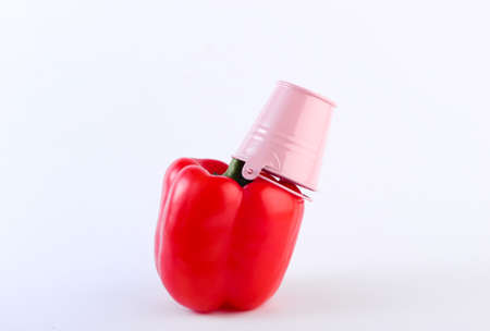 Bell pepper and a mini bucket on a white backgroundの写真素材