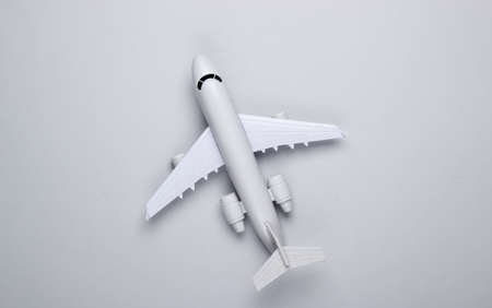 Toy model of plane on gray background. The concept of tourism, air travel, minimalism. Top viewの写真素材